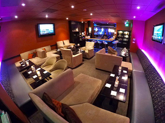 A spacious lounge with comfortable couches and tables for relaxation and socializing.