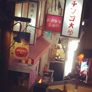 Inside of the restaurant, adorned with traditional downtown decor and filled with signs and people.