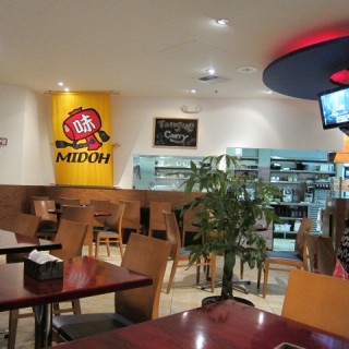 Interior of Midoh with tables, chairs, and a television.