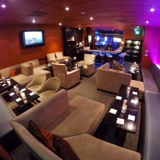 A spacious lounge with comfortable couches and tables for relaxation and socializing.