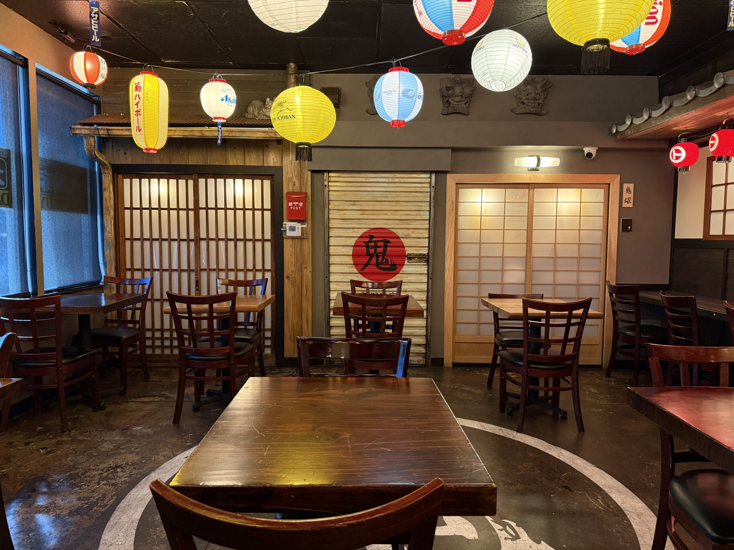 Dining room at Daikokuya Torrance with shoji sliding doors, wooden tables, and hanging paper lanterns.